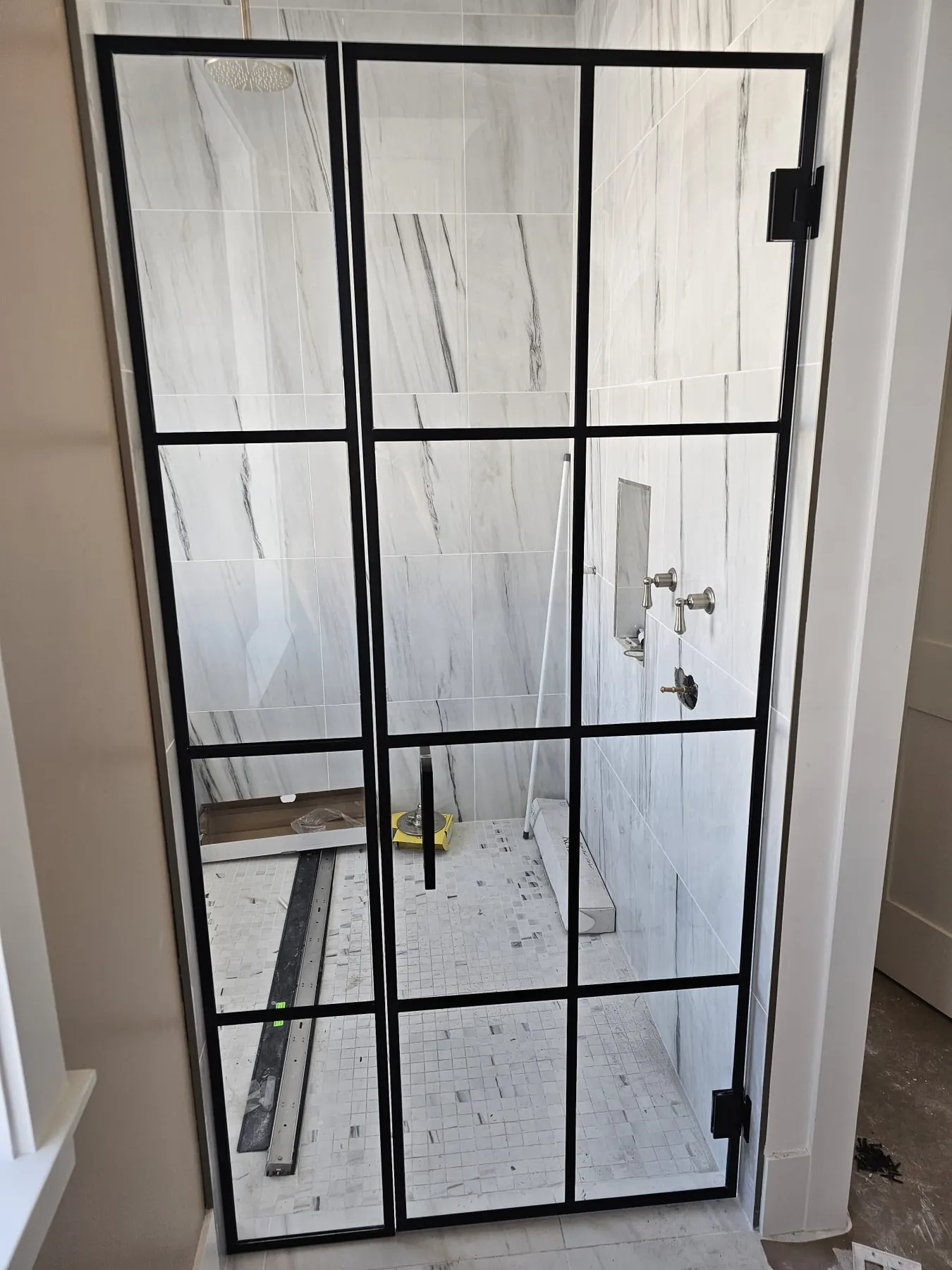 after framed swing shower glass with black hardware in Southwest Florida