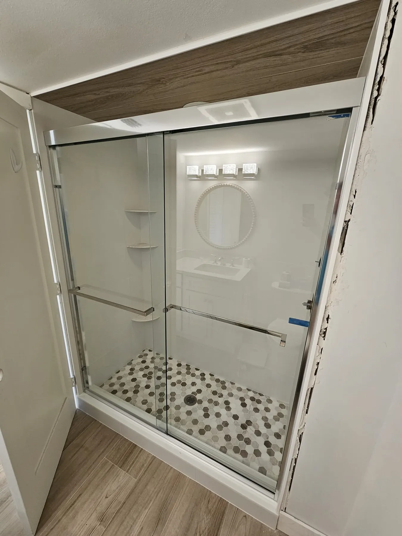 after framed sliding shower glass with chrome hardware in Southwest Florida