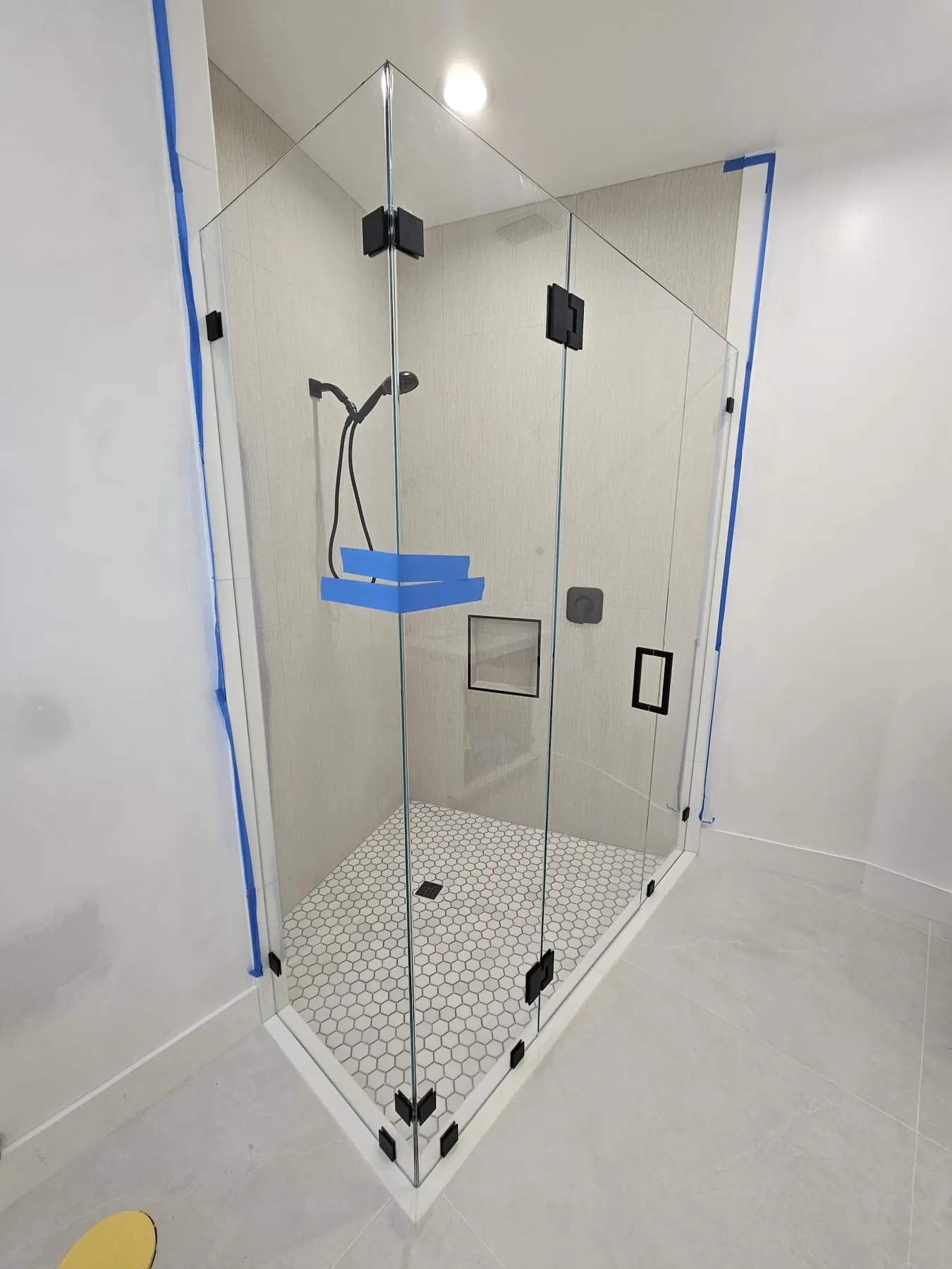 after frameless swing shower glass with black hardware in Southwest Florida