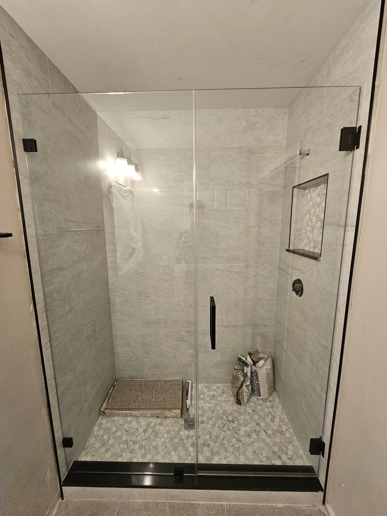 after frameless swing shower glass with black hardware in Southwest Florida