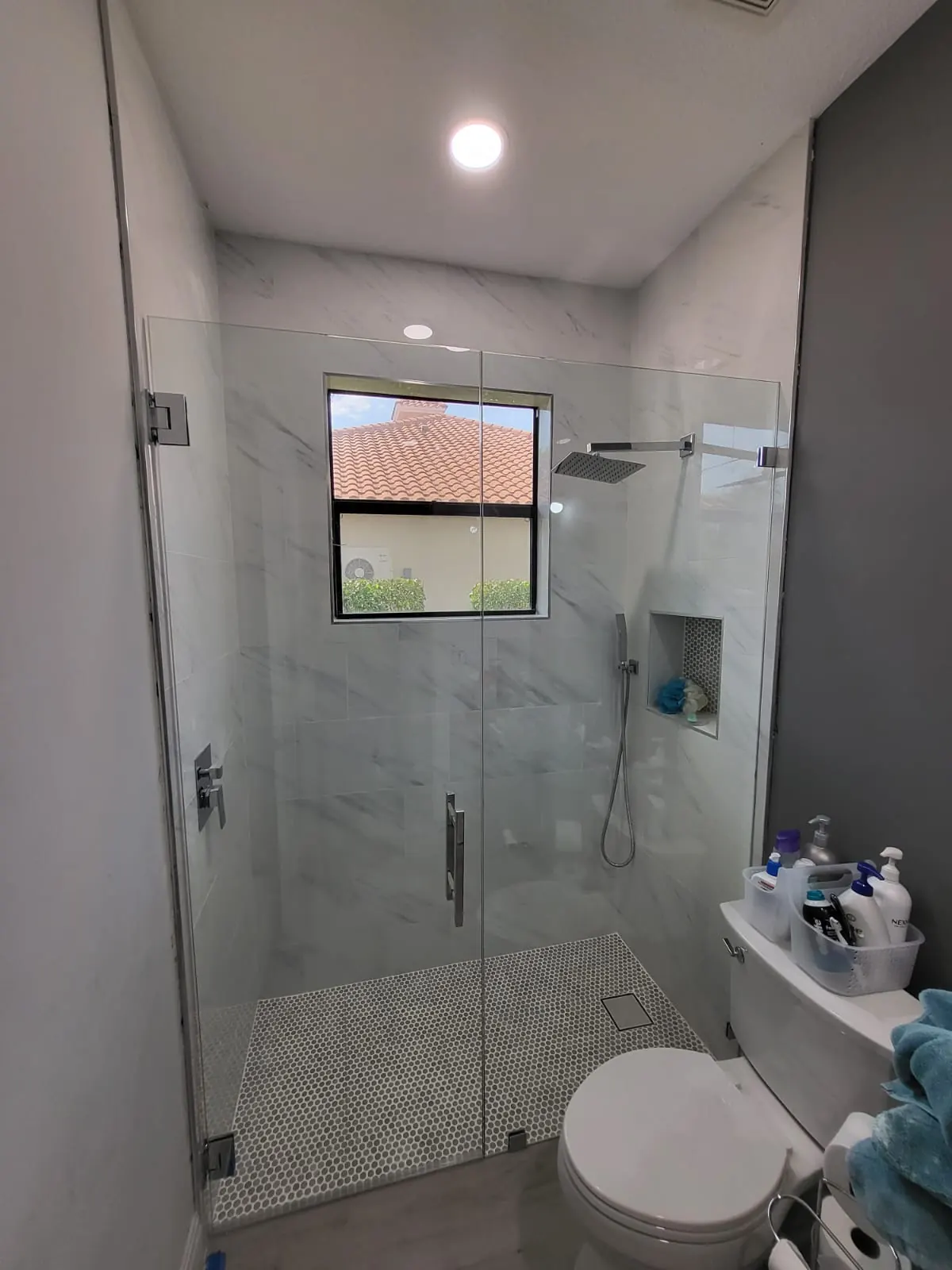 after frameless swing shower glass with chrome hardware in Southwest Florida
