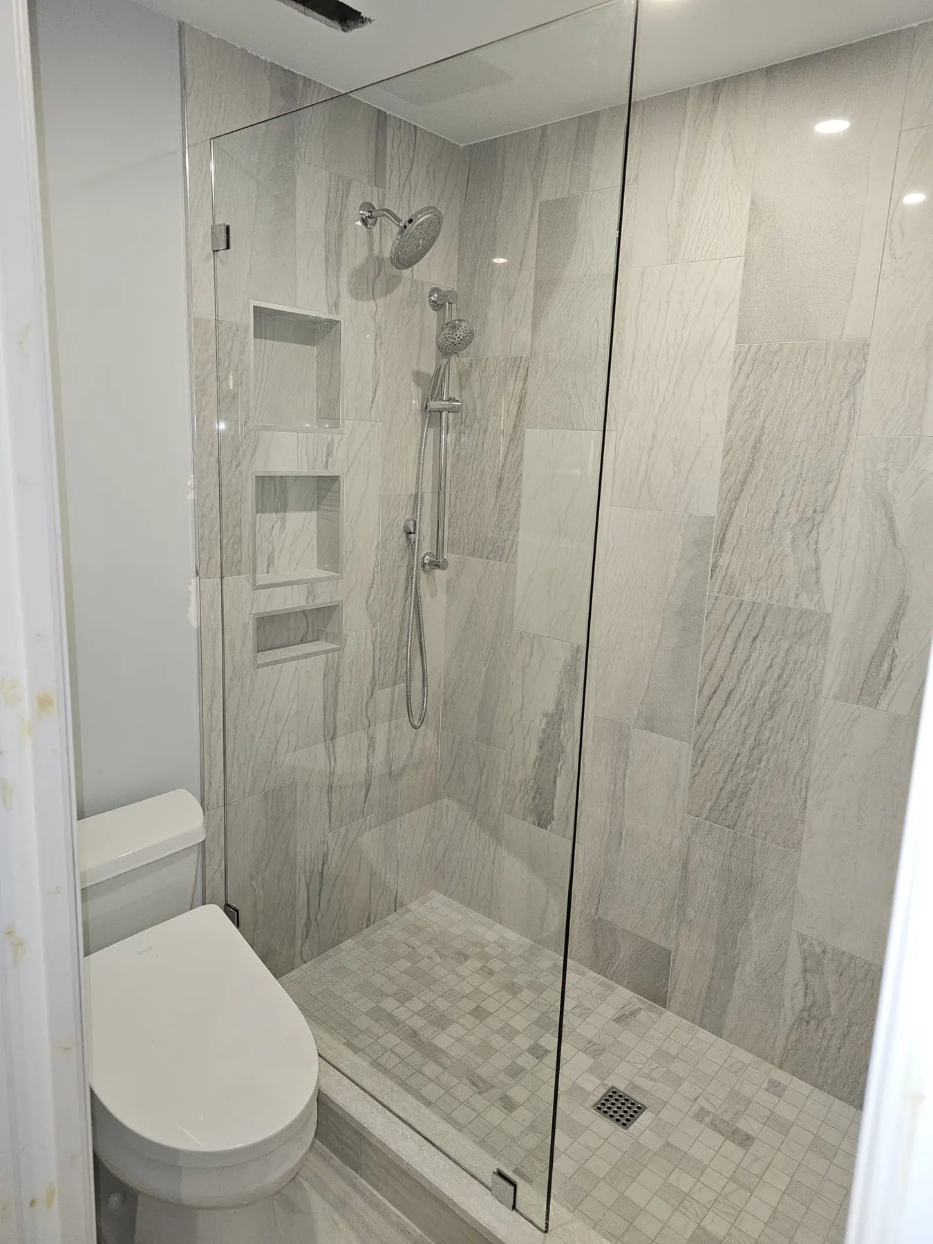 after frameless shower glass with chrome hardware in Southwest Florida