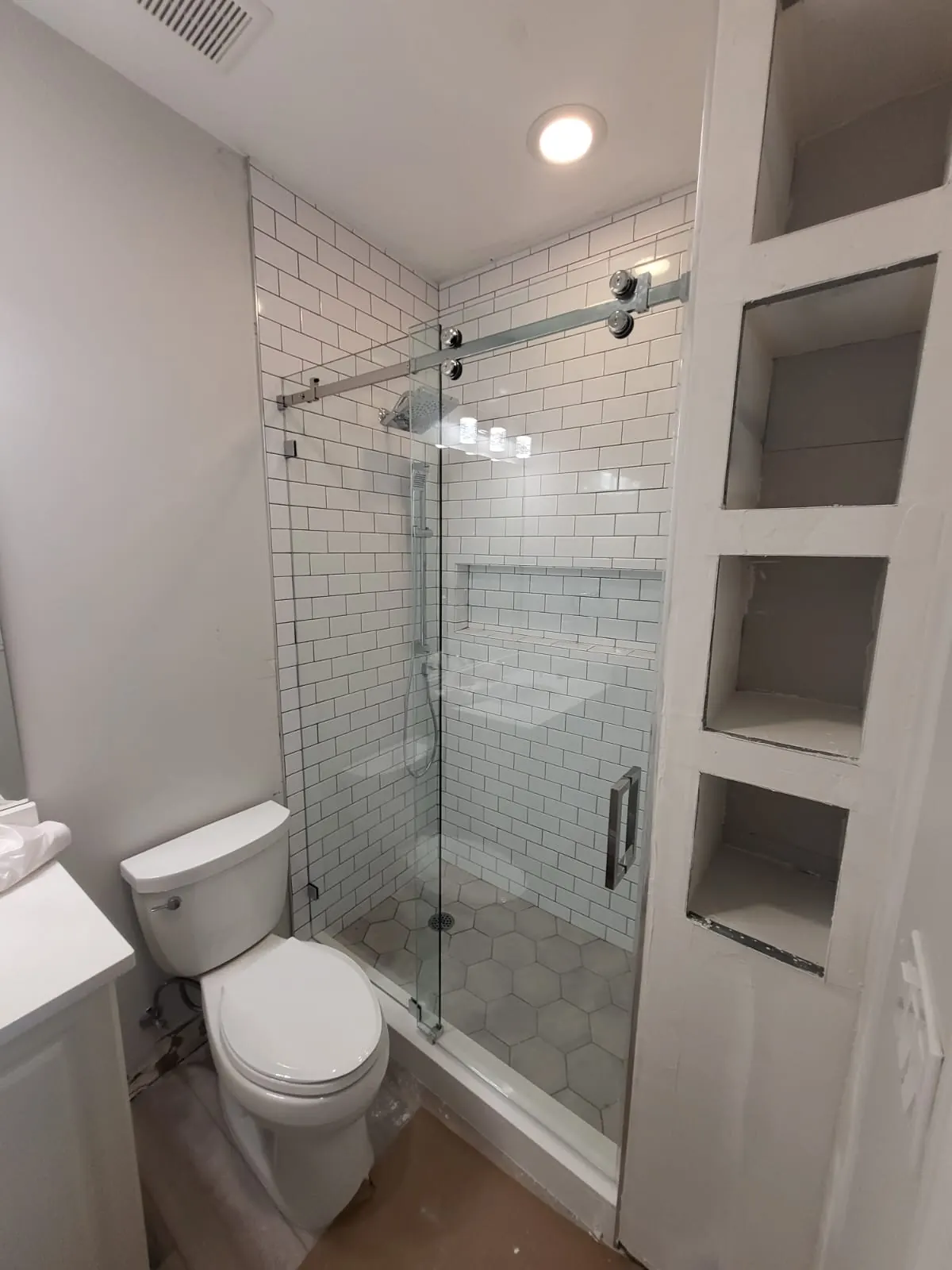 after frameless sliding shower glass with chrome hardware in Southwest Florida