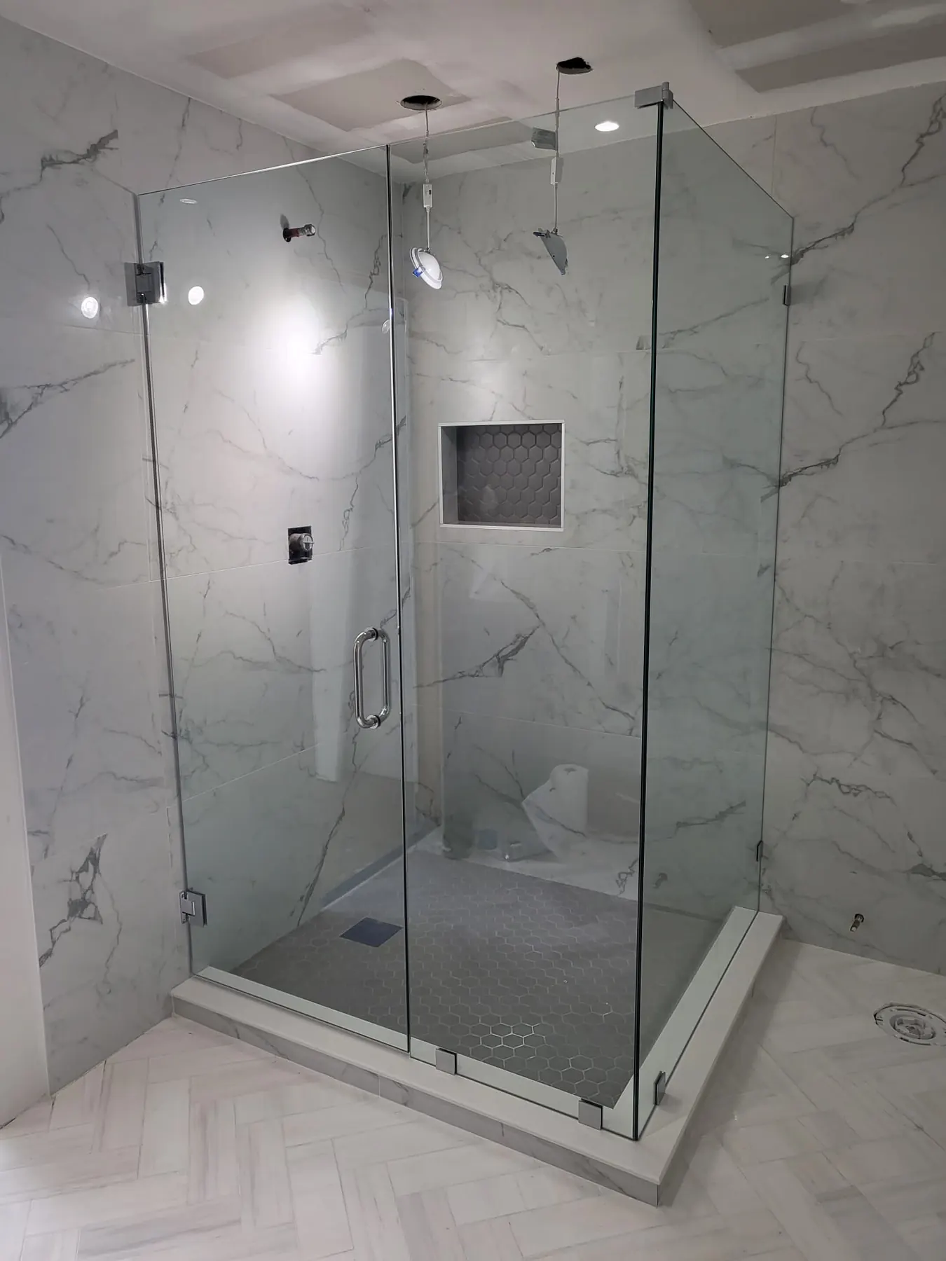 after frameless swing shower glass with chrome hardware in Southwest Florida