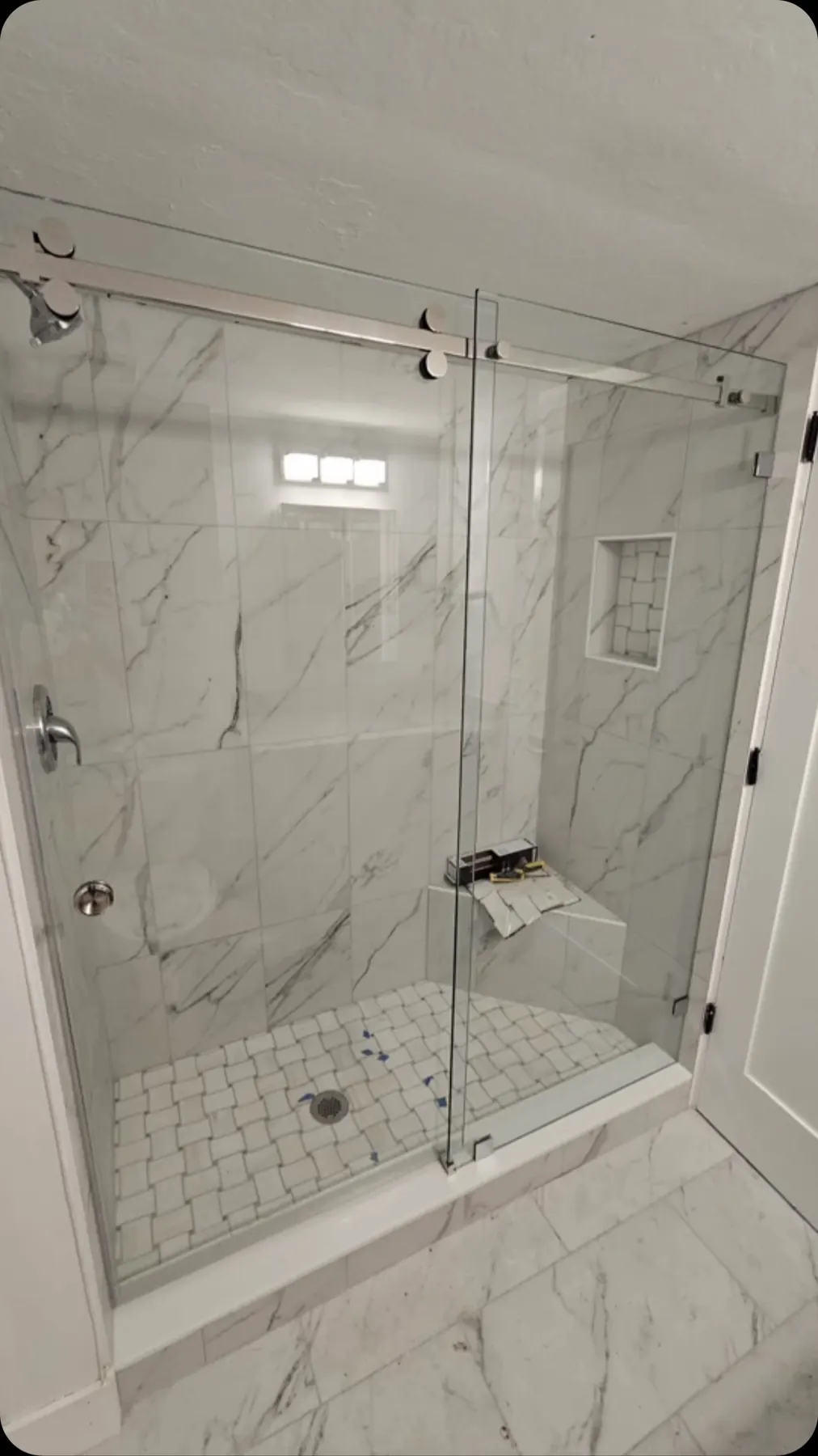 after frameless sliding shower glass with chrome hardware in Southwest Florida