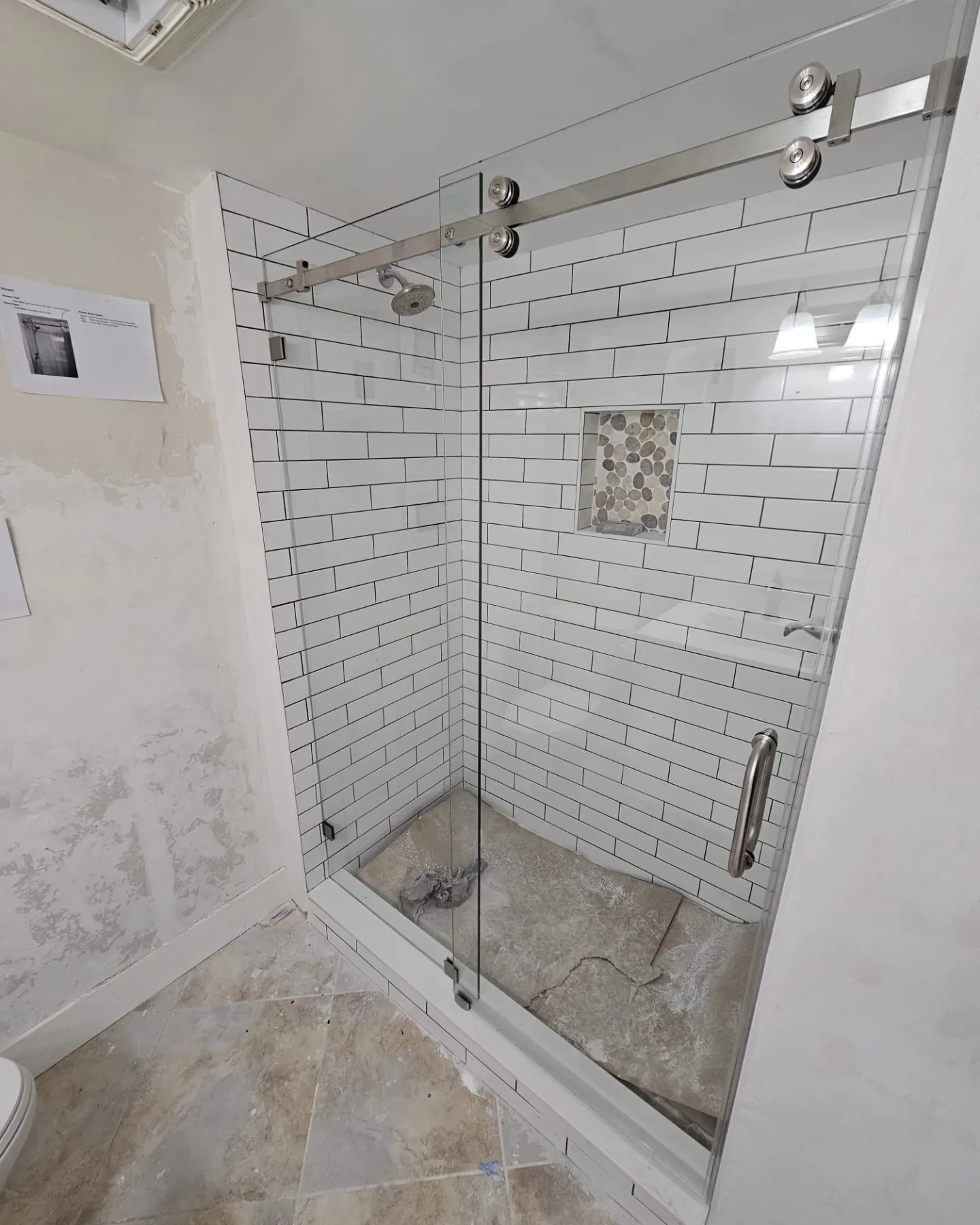 after frameless sliding shower glass with chrome hardware in Southwest Florida