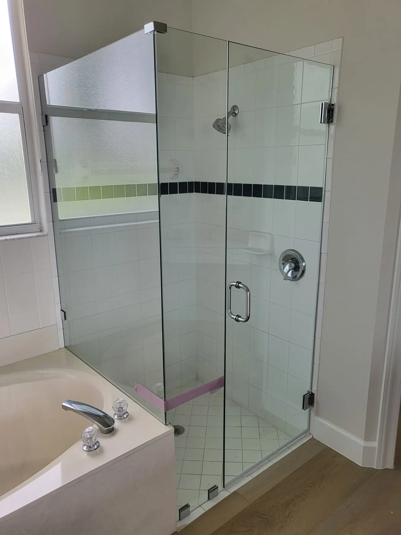 after frameless swing shower glass with chrome hardware in Southwest Florida