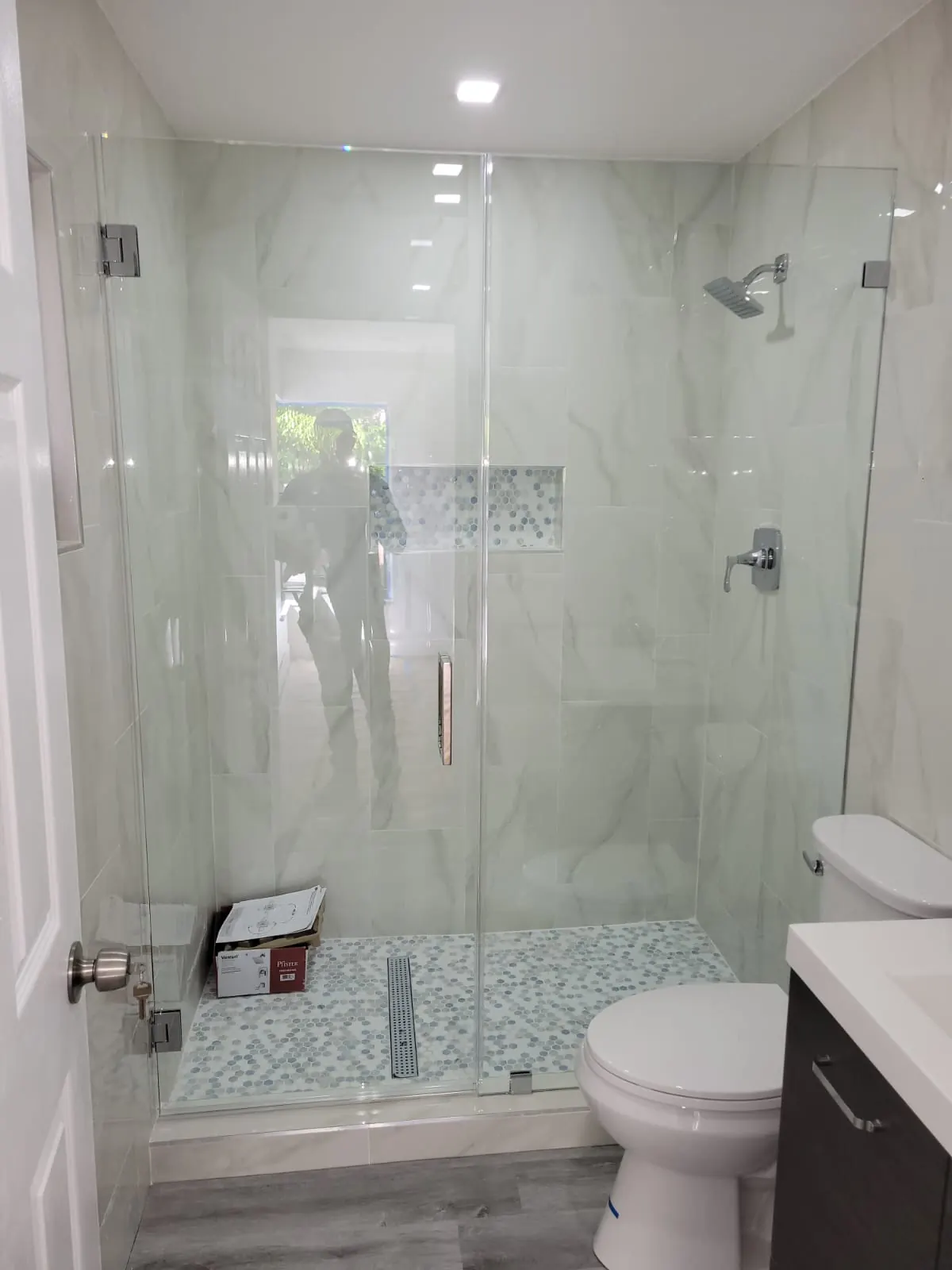 after frameless swing shower glass with chrome hardware in Southwest Florida