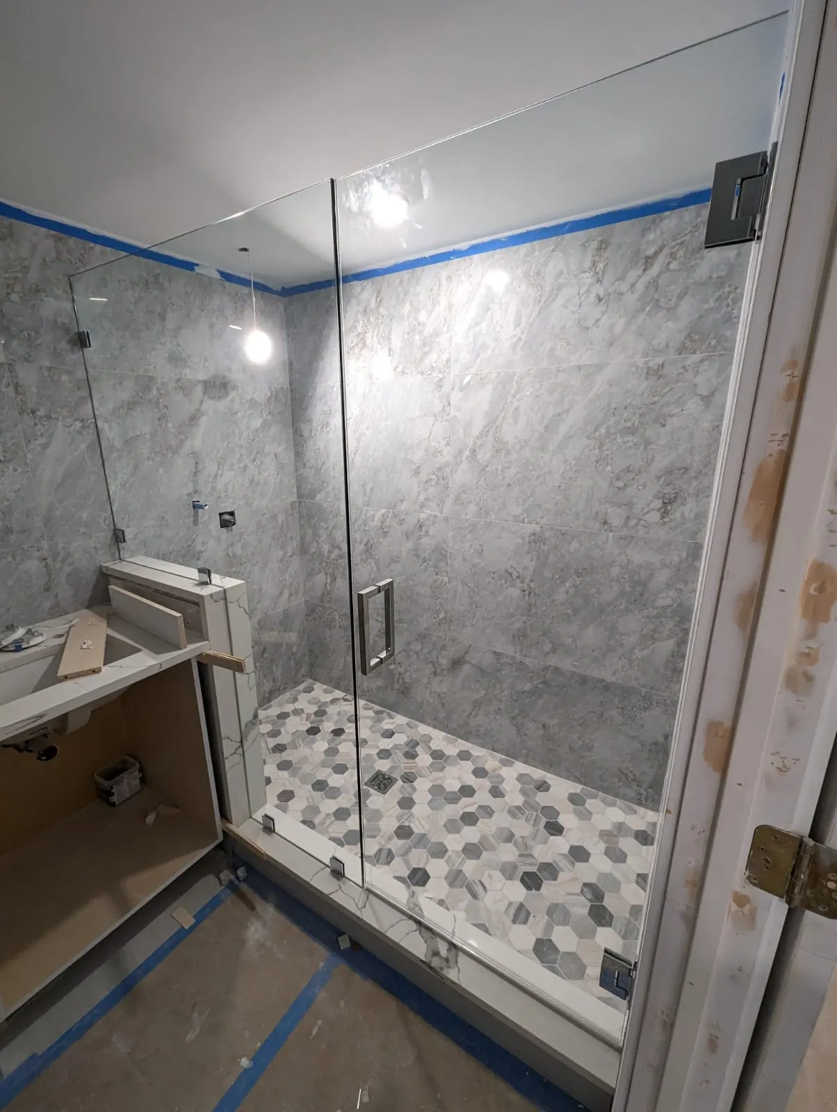 after frameless swing shower glass with chrome hardware in Southwest Florida