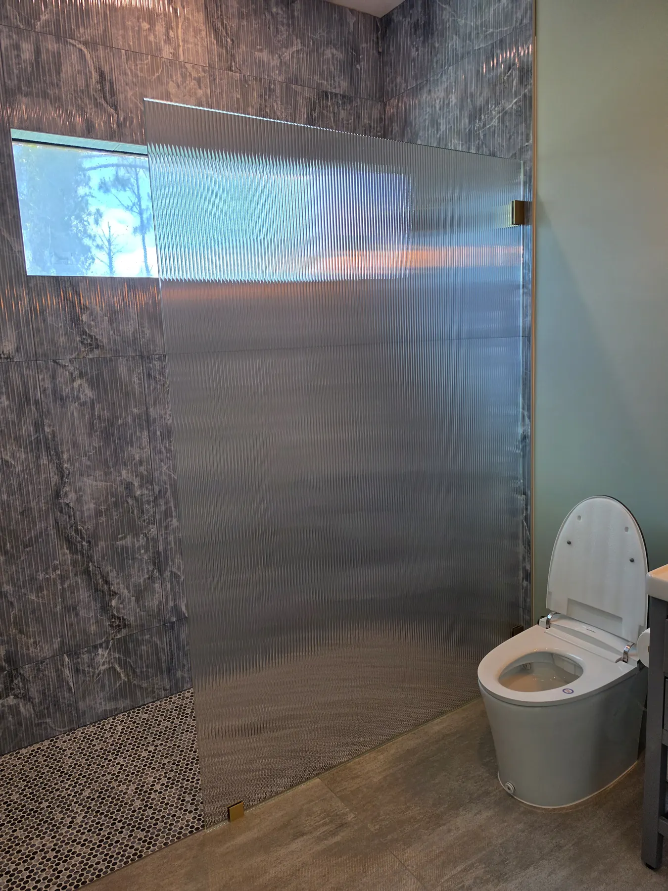 after frameless shower glass with brushed gold hardware in Southwest Florida