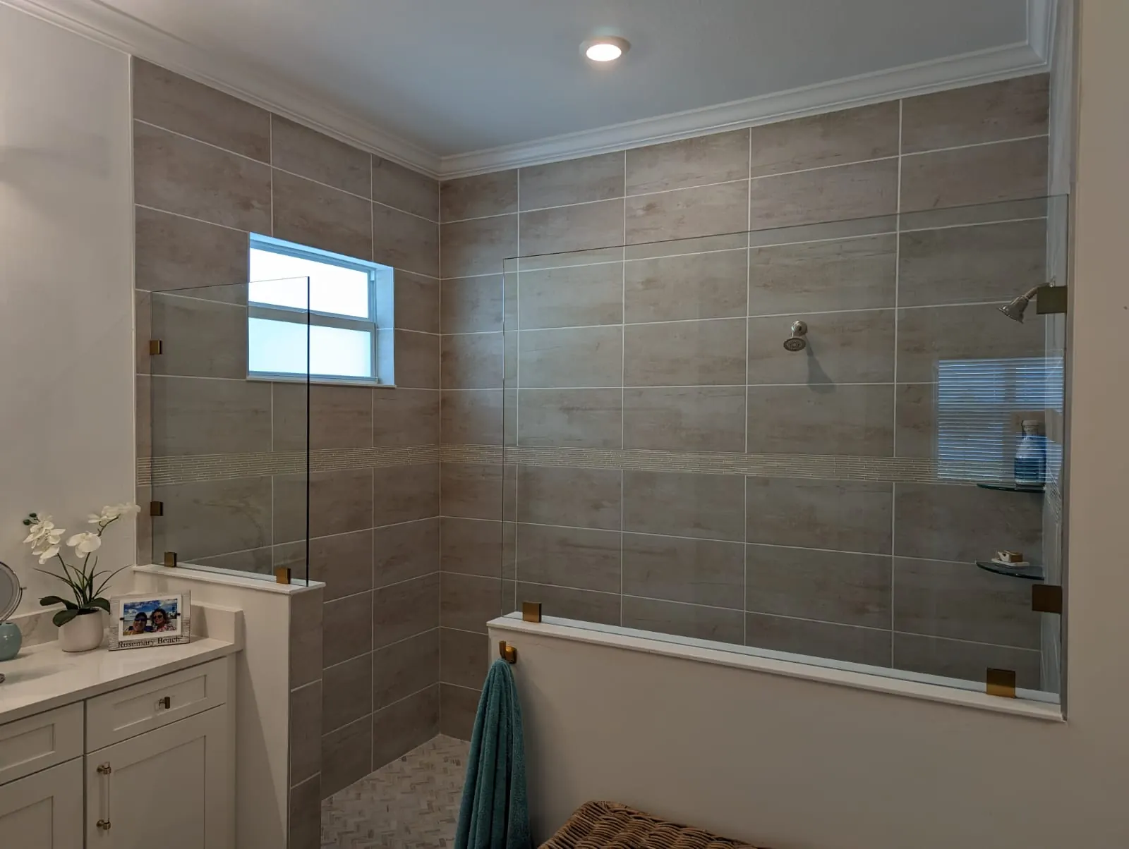 after frameless shower glass with brushed gold hardware in Southwest Florida