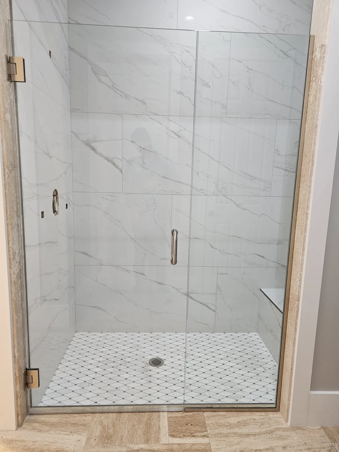 after frameless swing shower glass with brushed nickel hardware in Southwest Florida