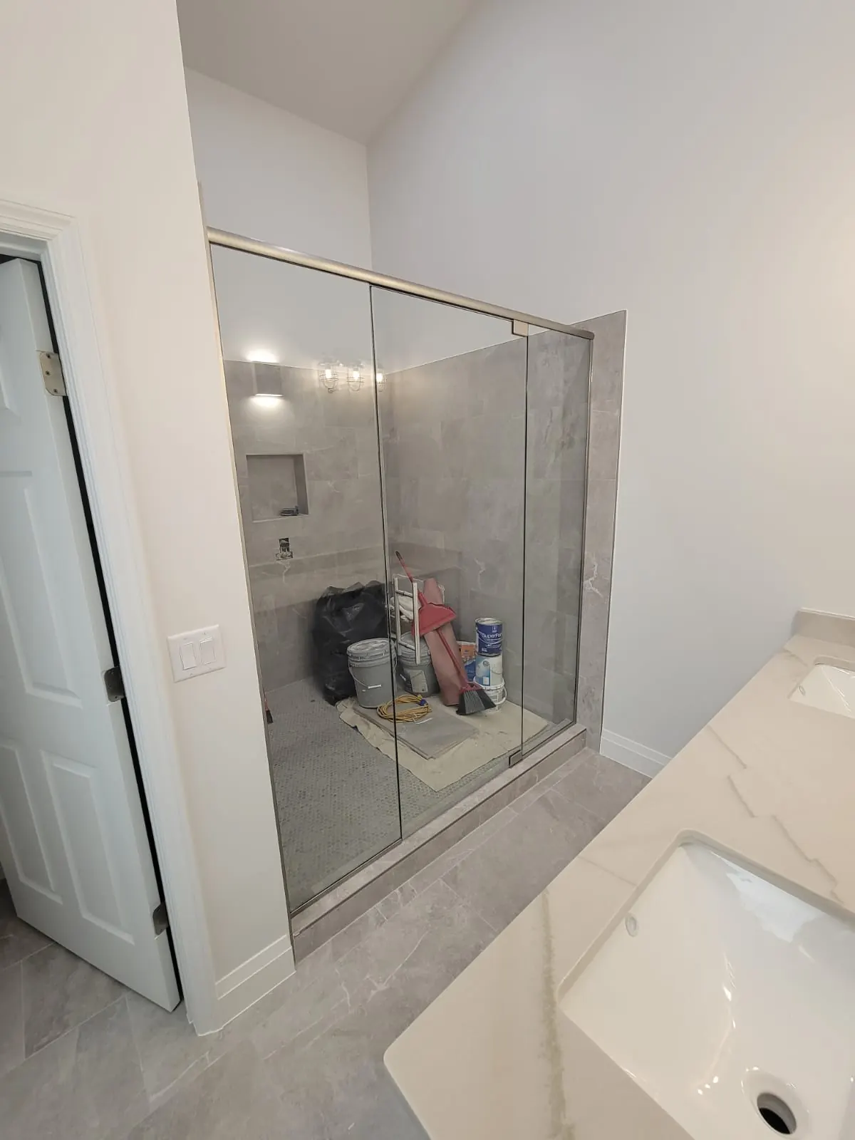 after frameless swing shower glass with brushed nickel hardware in Southwest Florida