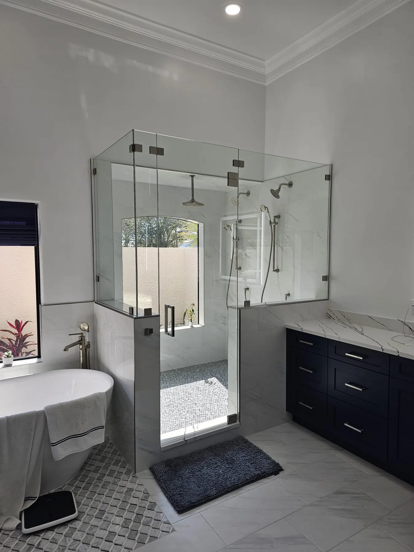 after frameless swing shower glass with brushed nickel hardware in Southwest Florida