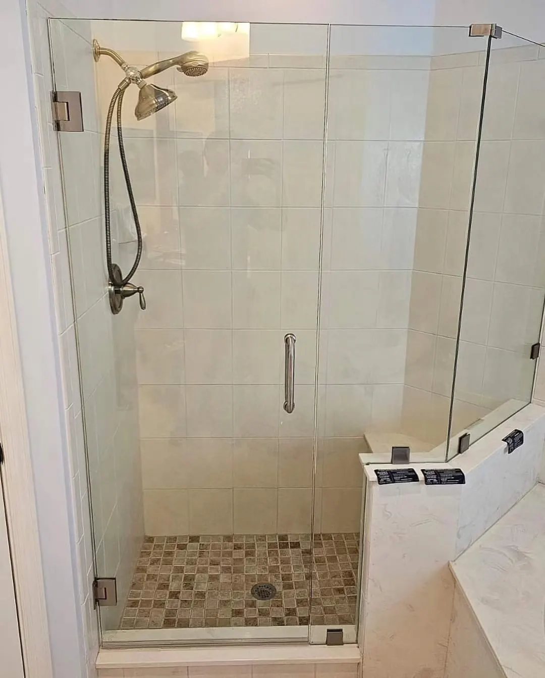 after frameless swing shower glass with brushed nickel hardware in Southwest Florida