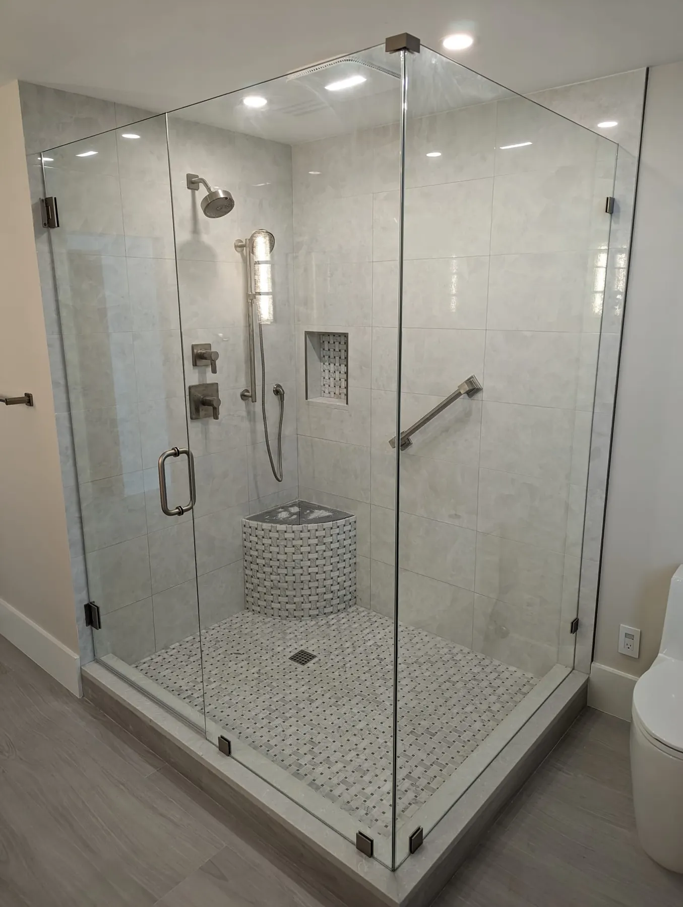 after frameless swing shower glass with brushed nickel hardware in Southwest Florida