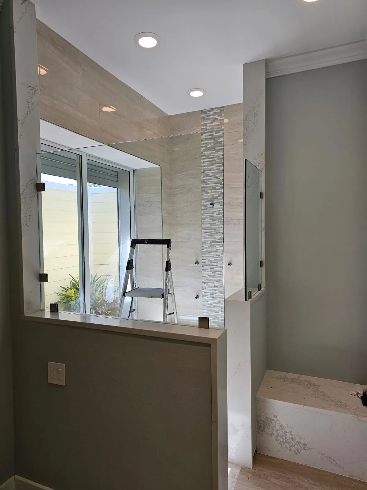 after frameless shower glass with brushed nickel hardware in Southwest Florida