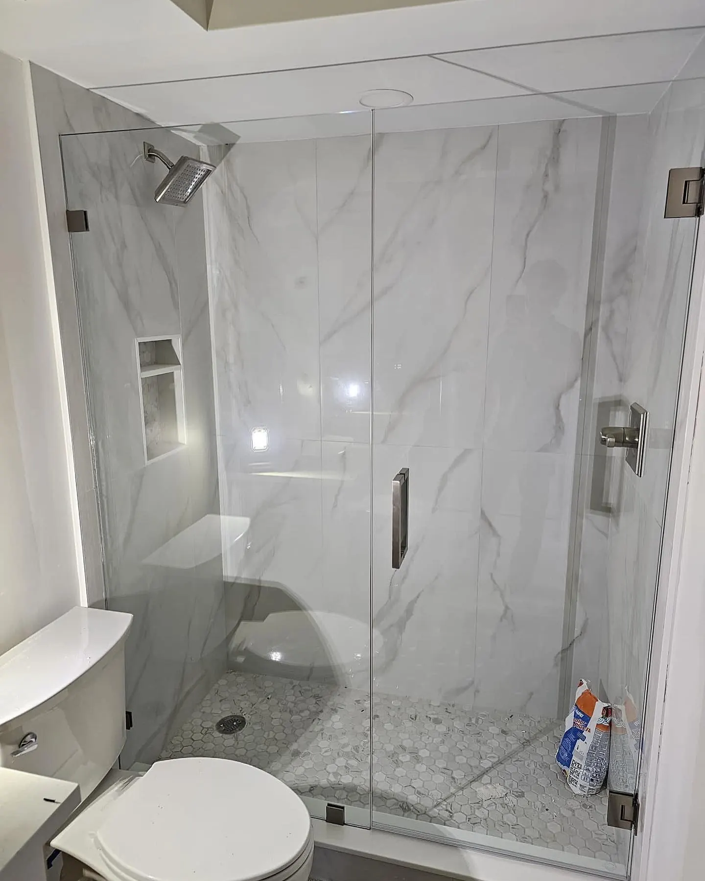 after frameless swing shower glass with brushed nickel hardware in Southwest Florida